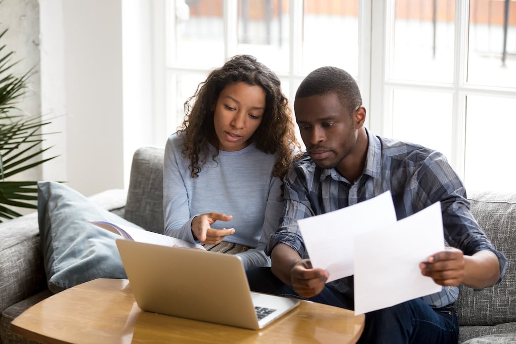couple reviewing their insurance company policy for roof replacement questions
